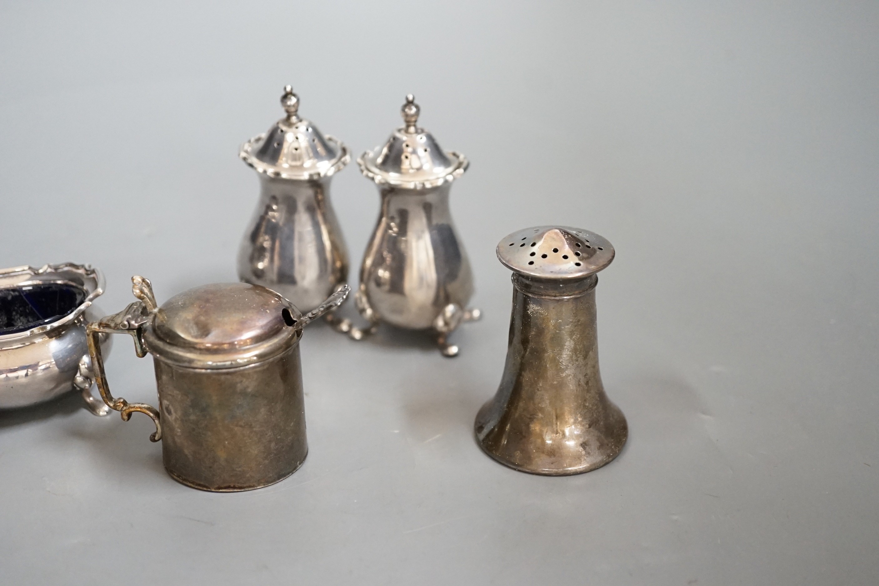 A George V silver four piece condiment set, Birmingham, 1922 and three other silver condiments.